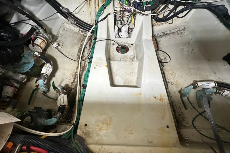 Slide: The Image of Engine compartment of a 2008 Pursuit OS 335 Offshore boat, showing wiring and plumbing. - 40