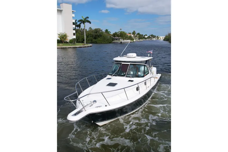 Slide: The Image of 2008 Pursuit OS 335 Offshore boat cruising on a scenic waterway. - 42