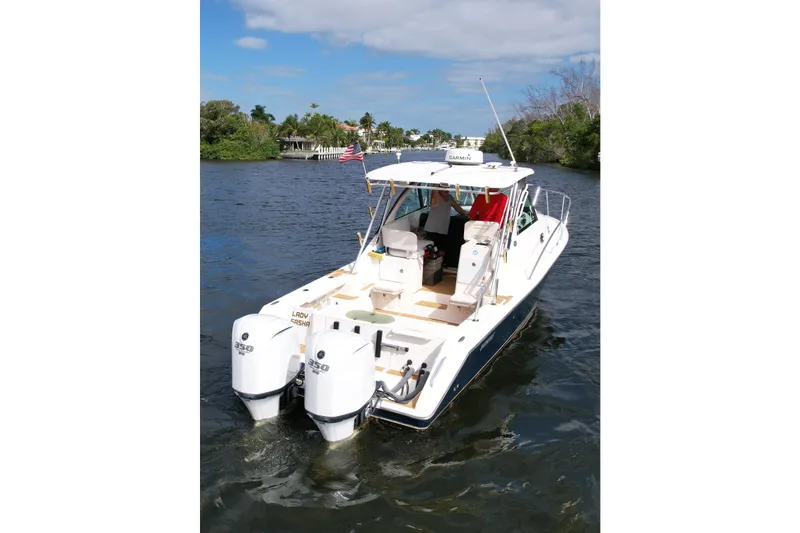 Slide: The Image of 2008 Pursuit OS 335 Offshore boat cruising on a scenic waterway. - 43