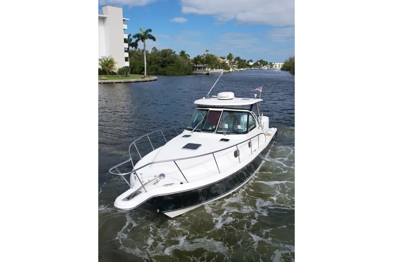 Slide: The Image of 2008 Pursuit OS 335 Offshore boat cruising on a scenic waterway. - 45