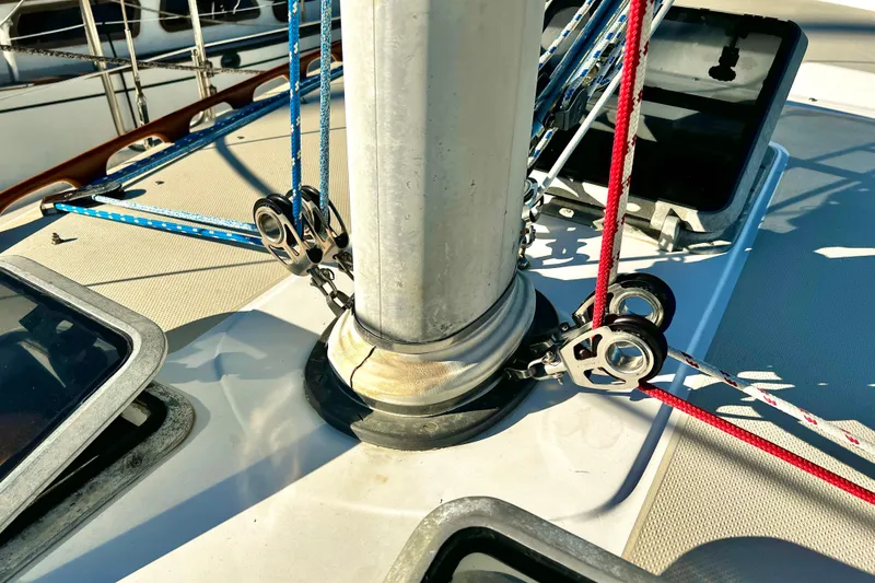 Slide: The Image of Close-up of Catalina 36 sailboat rigging, showcasing ropes and pulleys on deck. - 14