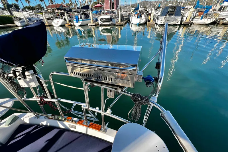 Slide: The Image of Catalina 36 sailboat with a stainless steel grill, docked in a marina, 1985 model. - 19