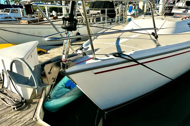 Slide: The Image of 1985 Catalina 36 sailboat docked at marina, featuring sleek white hull and deck. - 2