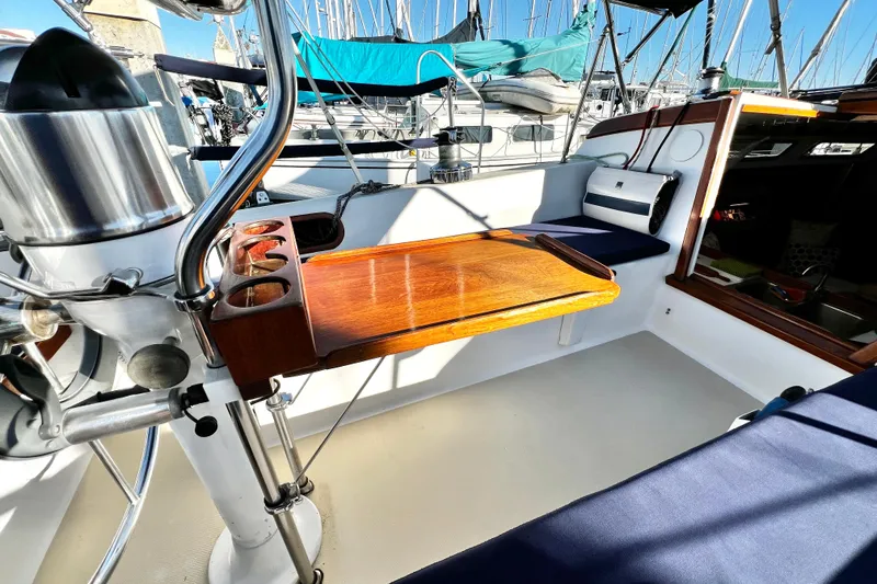 Slide: The Image of Cockpit of 1985 Catalina 36 sailboat with wooden table and seating. - 24