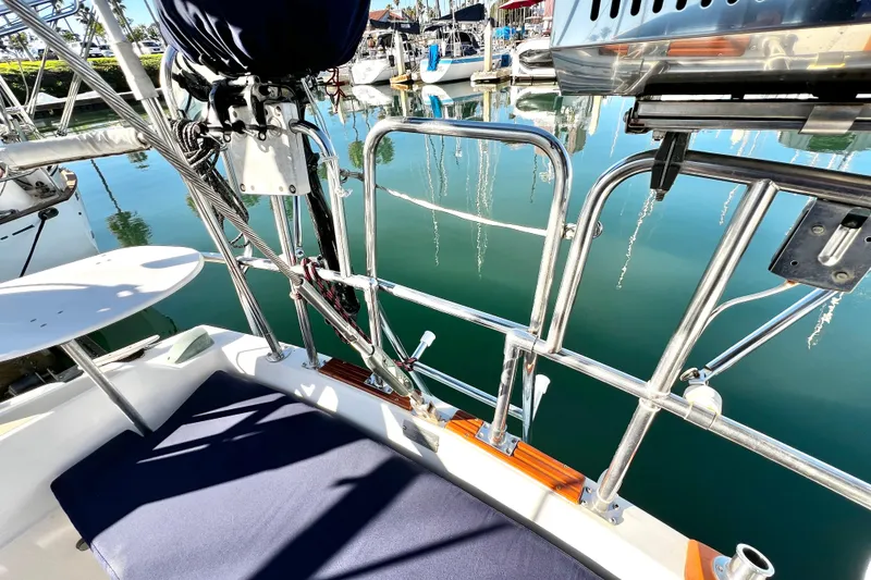 Slide: The Image of 1985 Catalina 36 sailboat deck with stainless steel railings in a marina setting. - 25