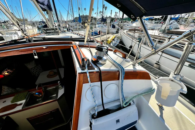 Slide: The Image of 1985 Catalina 36 sailboat cockpit with marina view, showcasing rigging and interior cabin. - 29