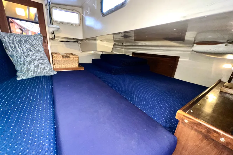 Slide: The Image of Interior cabin of 1985 Catalina 36 sailboat with blue upholstery and wooden accents. - 35
