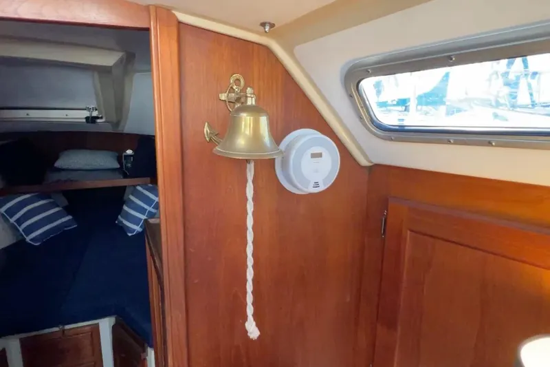 Slide: The Image of Interior of 1985 Catalina 36 sailboat with brass bell and smoke detector. - 42