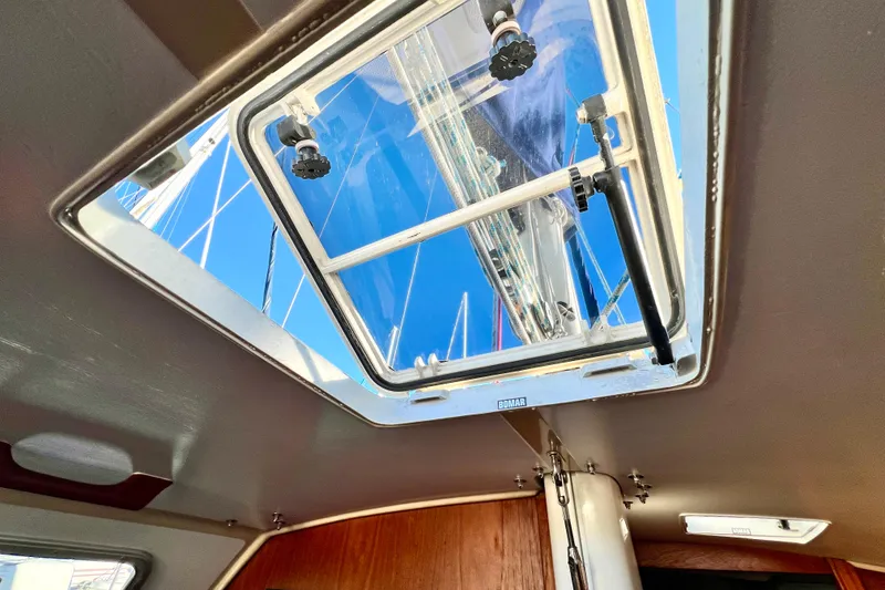 Slide: The Image of Interior view of 1985 Catalina 36 sailboat hatch, showcasing clear blue sky. - 48