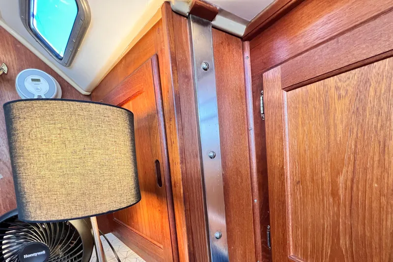 Slide: The Image of Interior of 1985 Catalina 36 sailboat with wooden cabinetry and modern lighting. - 49