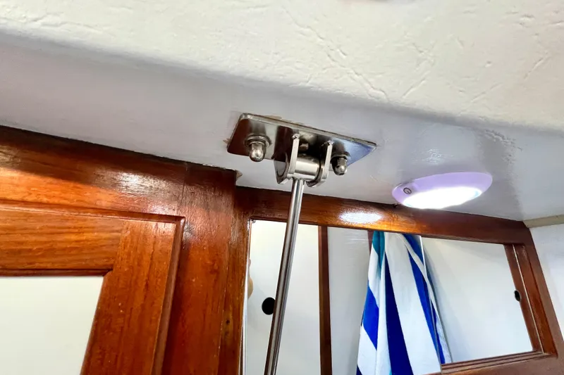 Slide: The Image of Interior of 1985 Catalina 36 sailboat showing wooden trim and stainless steel hardware. - 51