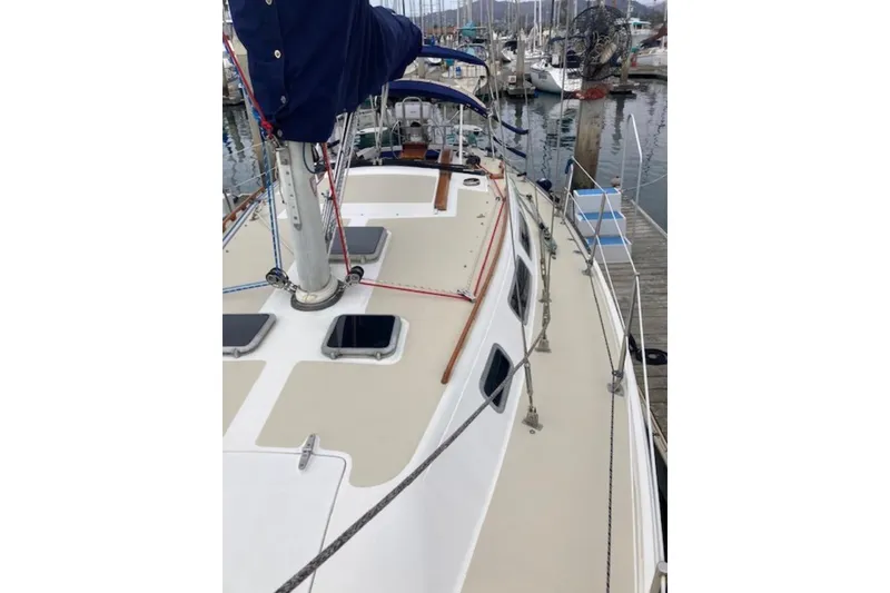 Slide: The Image of 1985 Catalina 36 sailboat docked at marina, showcasing deck and rigging. - 7