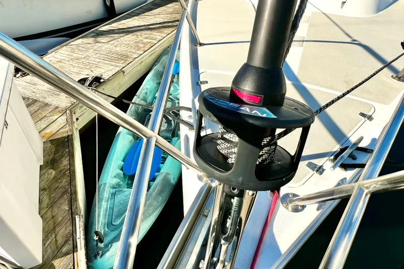 Slide: The Image of Bow of 1985 Catalina 36 sailboat with furling system and docked kayak. - 8