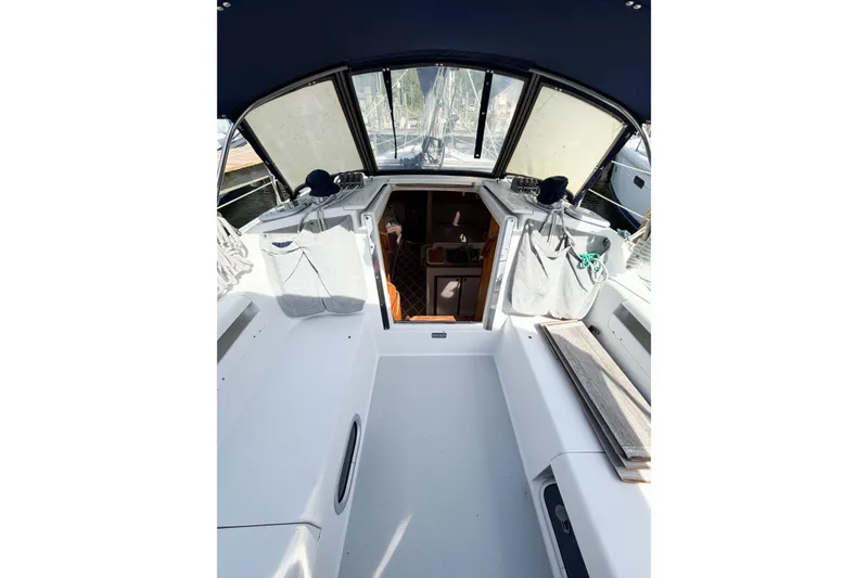 Slide: The Image of 2003 Catalina 34 MkII sailboat cockpit with covered seating and open cabin entrance. - 10