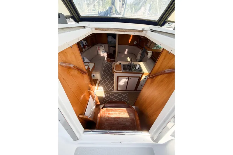 Slide: The Image of Interior view of 2003 Catalina 34 MkII sailboat, featuring cozy cabin and kitchenette. - 11