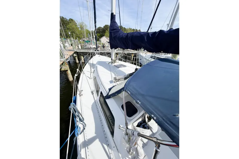 Slide: The Image of 2003 Catalina 34 MkII sailboat docked, featuring deck and rigging details. - 13