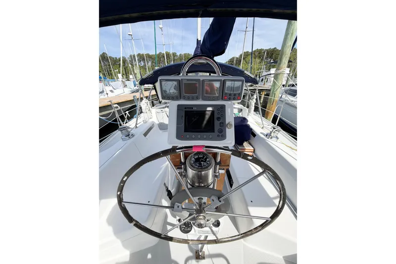 Slide: The Image of Cockpit of 2003 Catalina 34 MkII sailboat with steering wheel and navigation instruments. - 19