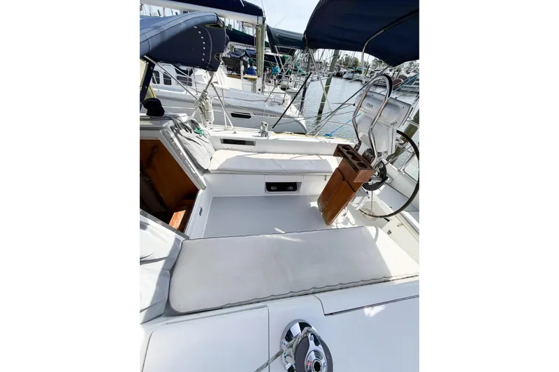Slide: The Image of 2003 Catalina 34 MkII sailboat cockpit with steering wheel and seating in marina. - 23
