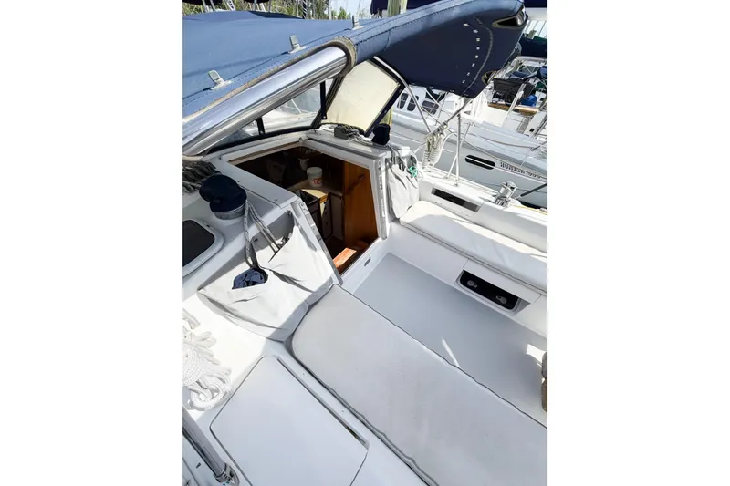 Slide: The Image of Cockpit of 2003 Catalina 34 MkII sailboat with blue canopy and white seating. - 24