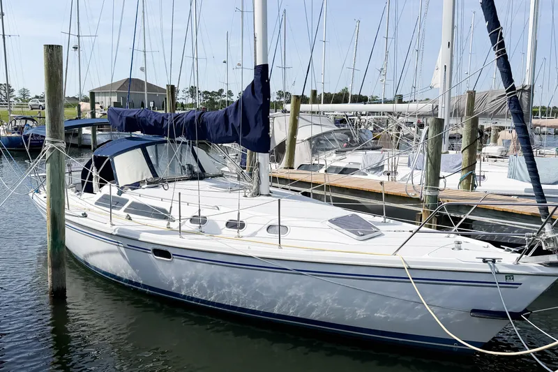 Slide: The Image of 2003 Catalina 34 MkII sailboat docked at a marina, surrounded by other boats. - 3