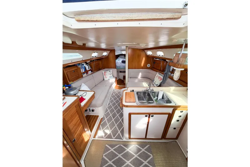 Slide: The Image of Interior of 2003 Catalina 34 MkII sailboat with cozy seating and compact kitchen area. - 31