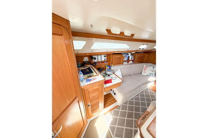 Slide: The Image of Interior of 2003 Catalina 34 MkII sailboat with cozy seating and wooden cabinetry. - 34