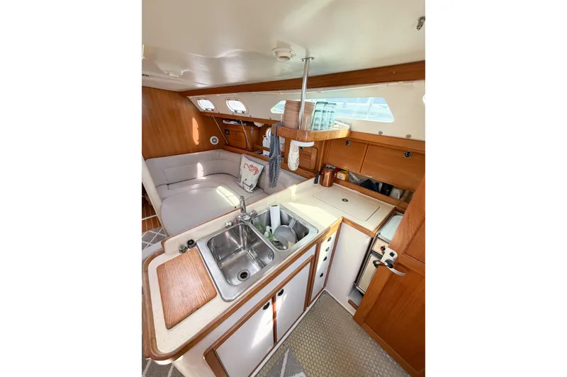 Slide: The Image of Interior of 2003 Catalina 34 MkII sailboat featuring a cozy galley and seating area. - 37