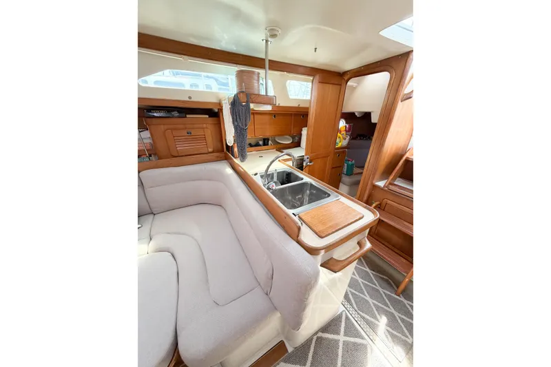 Slide: The Image of Interior of 2003 Catalina 34 MkII sailboat with cozy seating and compact kitchen area. - 38
