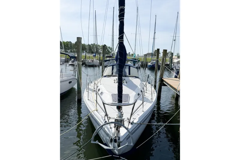 Slide: The Image of 2003 Catalina 34 MkII sailboat docked at a marina, surrounded by other boats. - 4