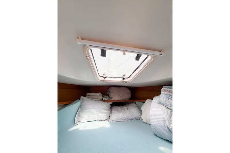 Slide: The Image of Cozy cabin interior of 2003 Catalina 34 MkII sailboat with bedding and hatch. - 44