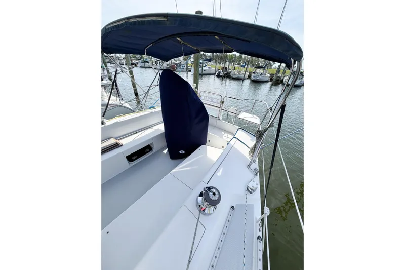 Slide: The Image of 2003 Catalina 34 MkII sailboat cockpit with blue canopy, docked at marina. - 5