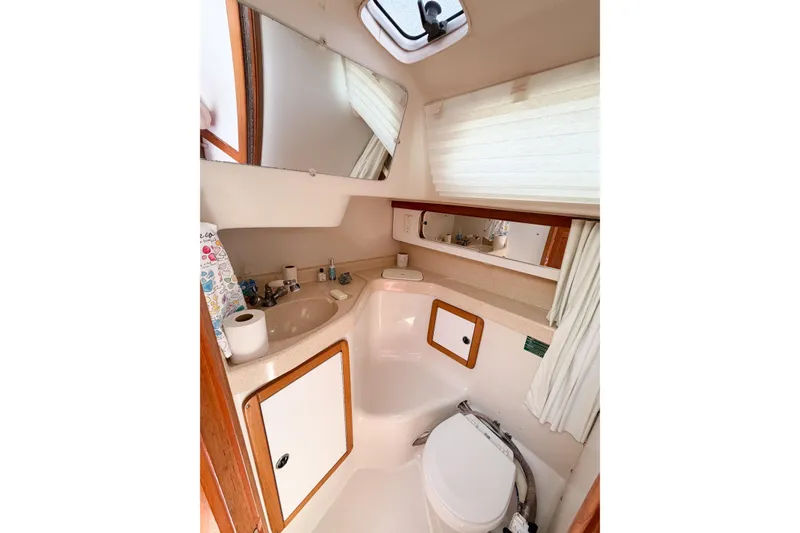 Slide: The Image of Compact bathroom in a 2003 Catalina 34 MkII sailboat, featuring a toilet and sink. - 52