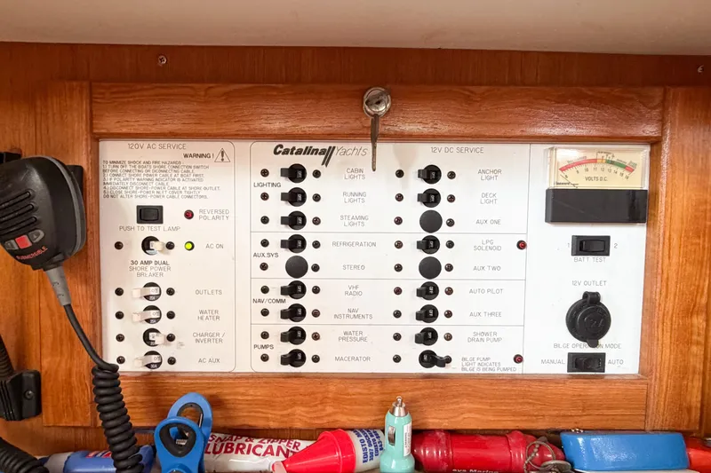Slide: The Image of Electrical control panel of a 2003 Catalina 34 MkII yacht with various switches and gauges. - 60