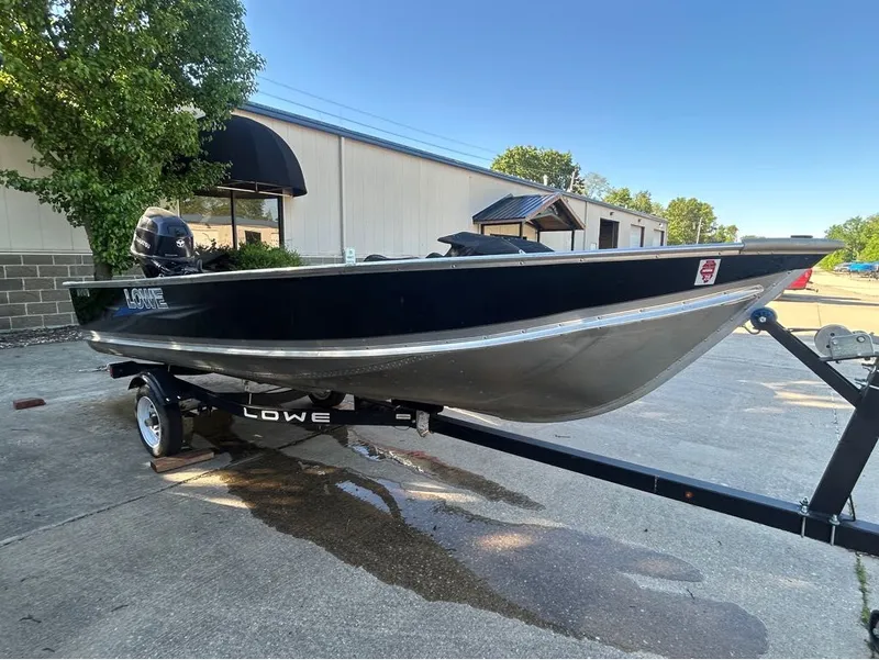 Slide: The Image of Black Lowe WV1470 boat from 2021 on trailer, parked outdoors. - 6