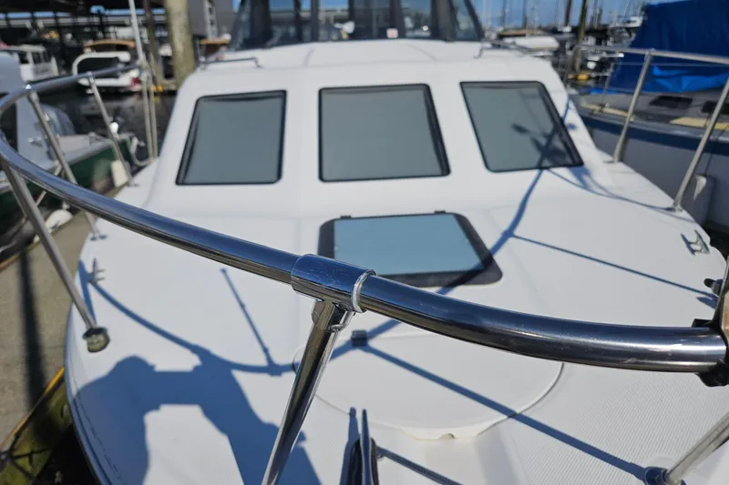 Slide: The Image of 2002 Bayliner 2859 Ciera Classic boat docked at marina, close-up of deck and railings. - 16