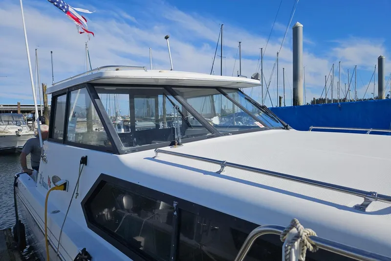 Slide: The Image of 2002 Bayliner 2859 Ciera Classic docked at marina with American flag. - 17