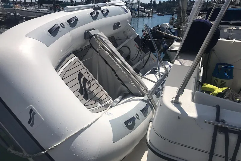 Slide: The Image of Inflatable boat on a 2002 Bayliner 2859 Ciera Classic, docked at a marina. - 19