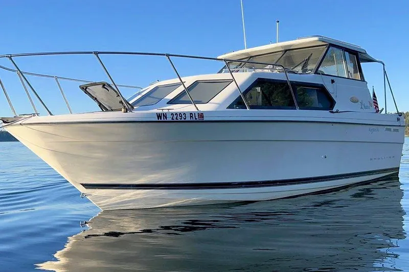 Slide: The Image of 2002 Bayliner 2859 Ciera Classic boat on calm water under clear blue sky. - 24