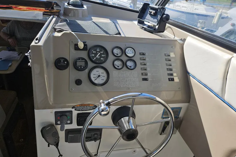 Slide: The Image of 2002 Bayliner 2859 Ciera Classic helm with gauges and steering wheel. - 5