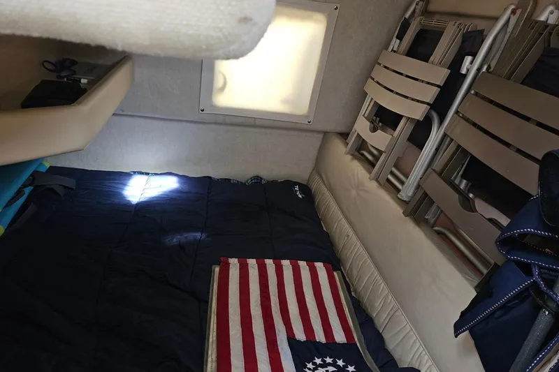 Slide: The Image of Interior cabin of 2002 Bayliner 2859 Ciera Classic with folded chairs and American flag. - 6