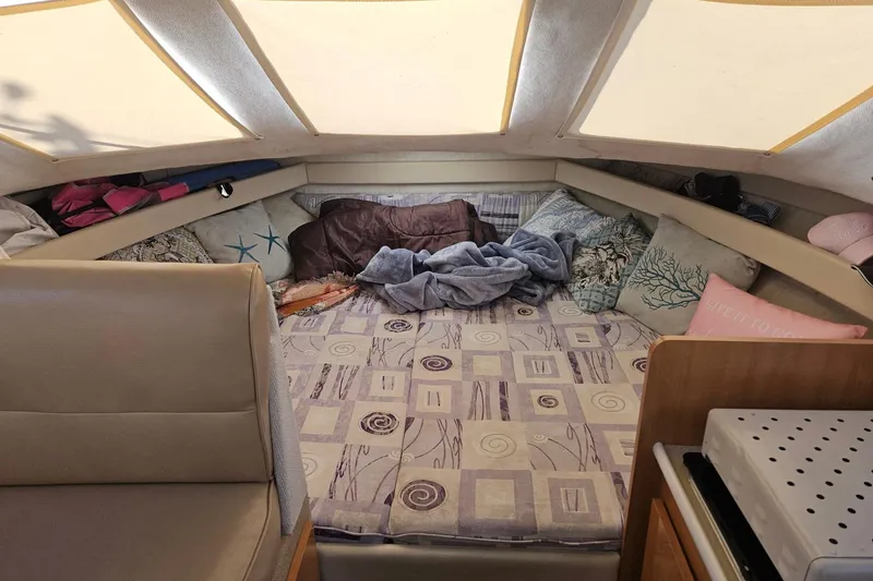 Slide: The Image of Cozy cabin interior of 2002 Bayliner 2859 Ciera Classic with cushions and bedding. - 8