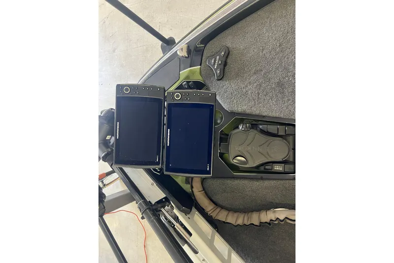 Slide: The Image of 2024 Skeeter FXR21 Apex boat storage compartment with open lid and sleek design. - 19