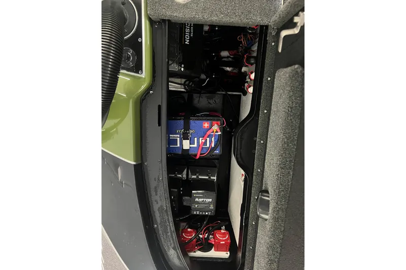 Slide: The Image of 2024 Skeeter FXR21 Apex storage compartment with open lid, showcasing interior space. - 20