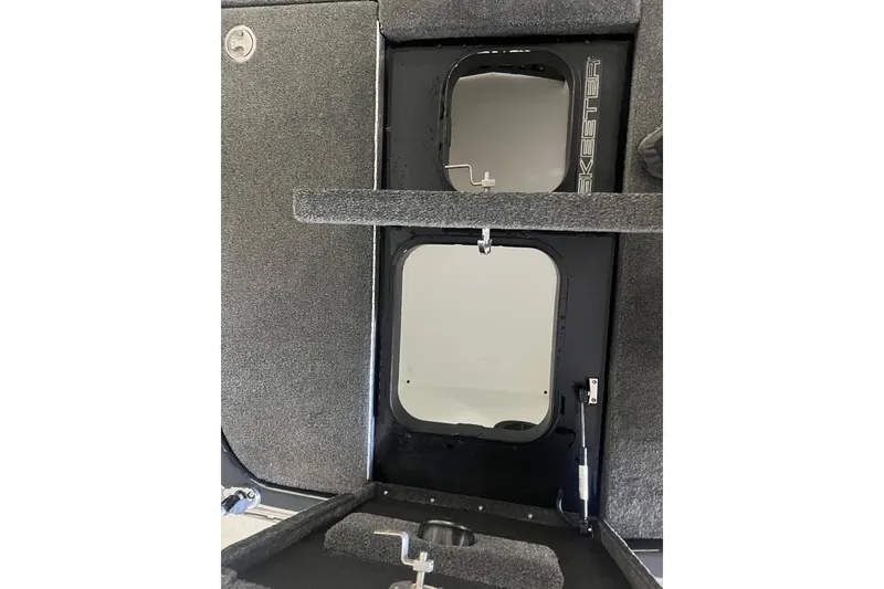 Slide: The Image of 2024 Skeeter FXR21 Apex boat interior with branded measuring tool on carpeted surface. - 21