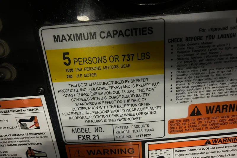 Slide: The Image of 2024 Skeeter FXR21 Apex boat interior with open storage compartment between seats. - 23