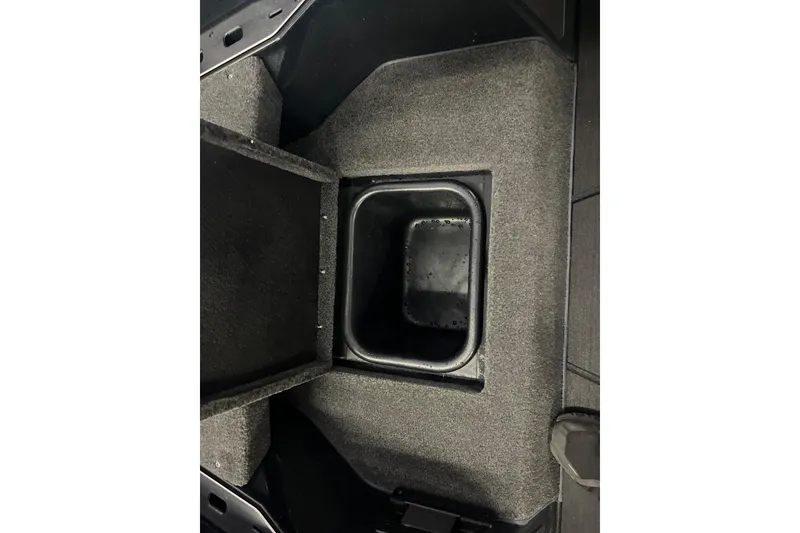 Slide: The Image of 2024 Skeeter FXR21 Apex boat interior with open storage compartments. - 25