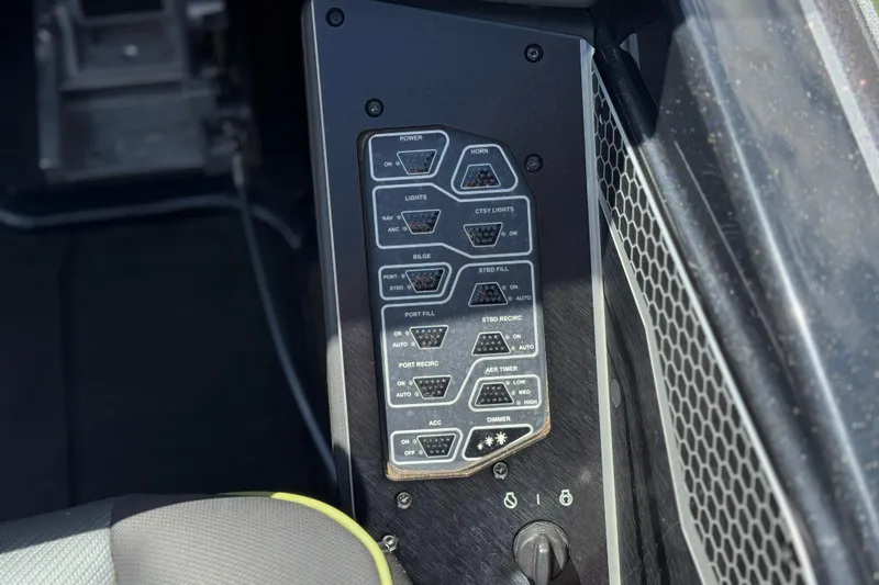 Slide: The Image of Control panel of 2024 Skeeter FXR21 Apex boat with various switches and settings. - 33