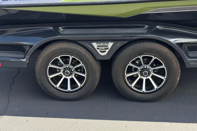 Slide: The Image of 2024 Skeeter FXR21 Apex trailer wheels with sleek black and silver rims. - 36