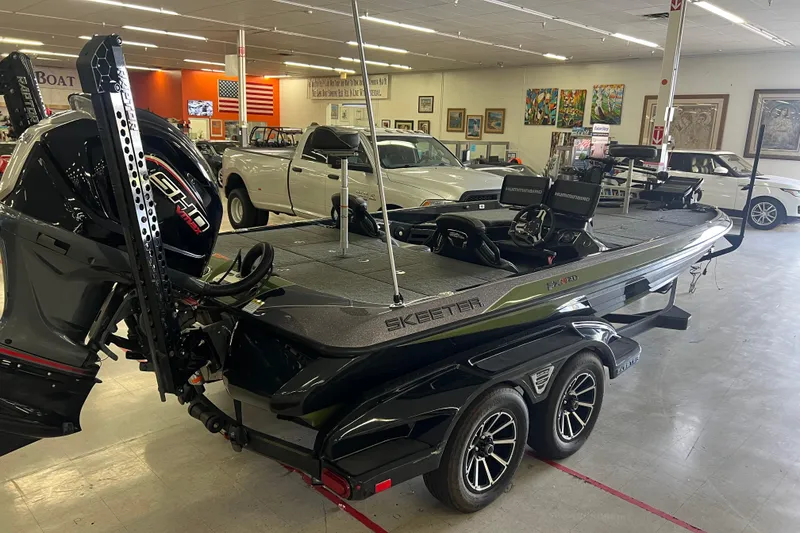 Slide: The Image of 2024 Skeeter FXR21 Apex boat with powerful outboard motor on a trailer. - 4