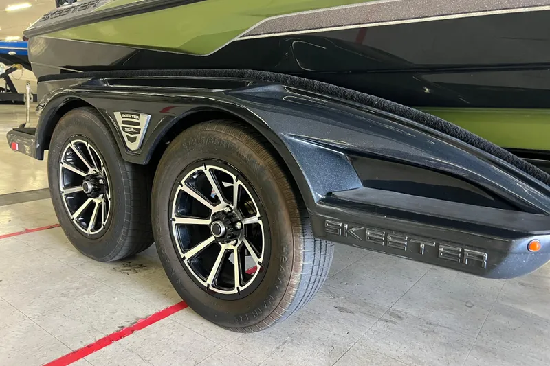 Slide: The Image of 2024 Skeeter FXR21 Apex boat with Yamaha engine, parked on a trailer. - 5